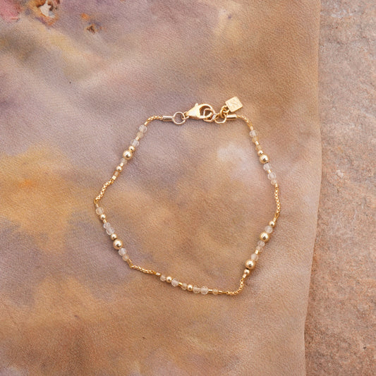 citrine and gold-filled beaded bracelet on a naturally-dyed silk cloth